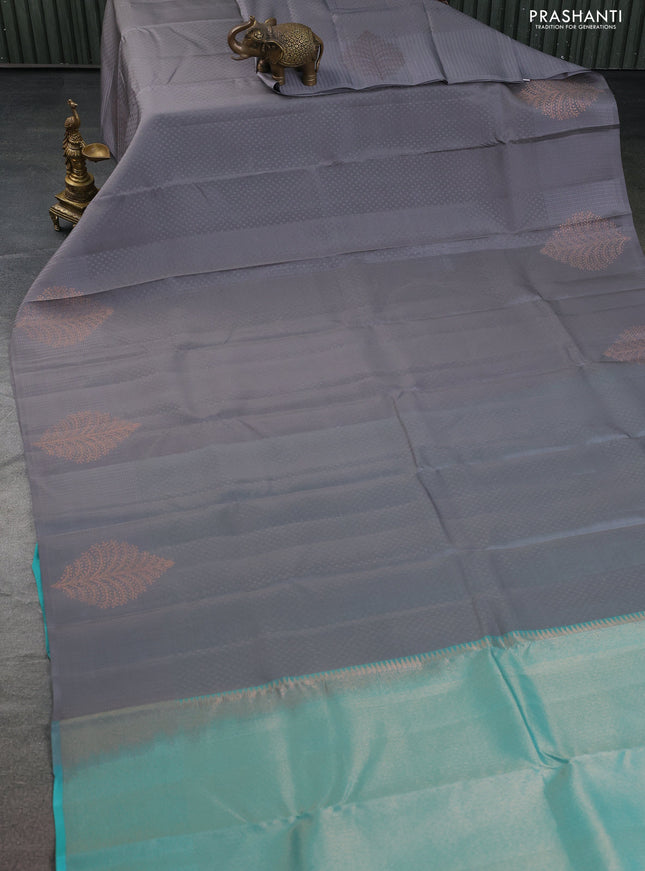 Kanchipuram silk saree grey and teal blue with allover self emboss and copper zari woven buttas