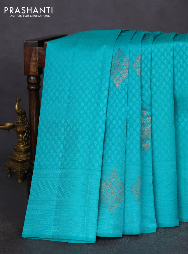 Kanchipuram silk saree teal blue and dual shade of pinkish orange with allover self emboss & copper zari buttas in borderless style