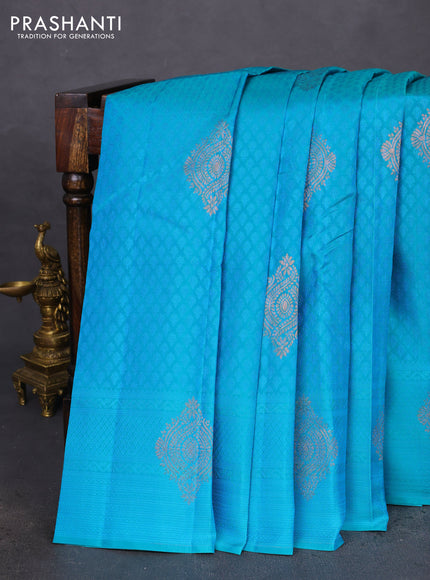 Kanchipuram silk saree dual shade of teal blue and dual shade of pinkish orange with allover self emboss & copper zari buttas in borderless style