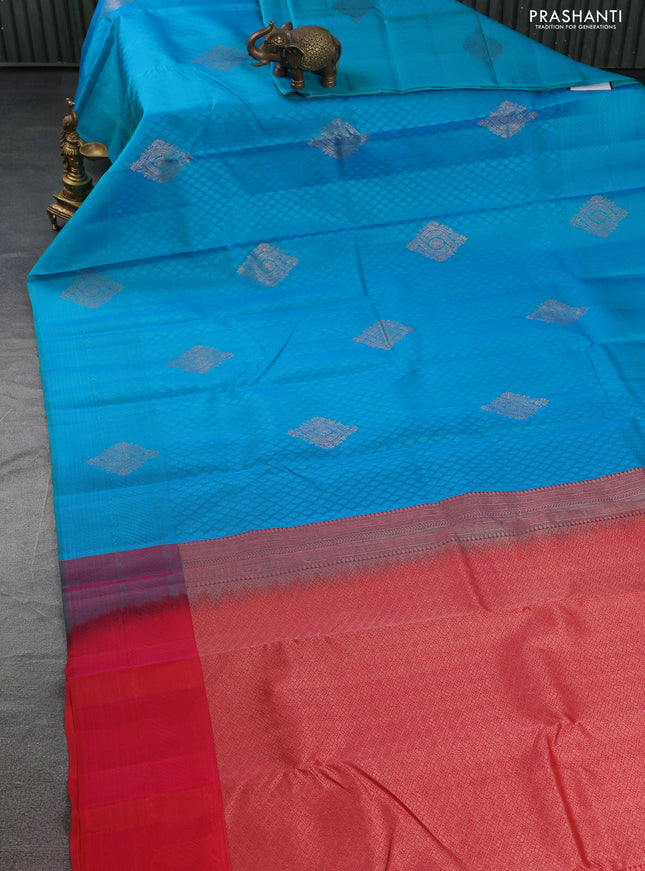 Kanchipuram silk saree dual shade of teal blue and dual shade of pinkish orange with allover self emboss & copper zari buttas in borderless style