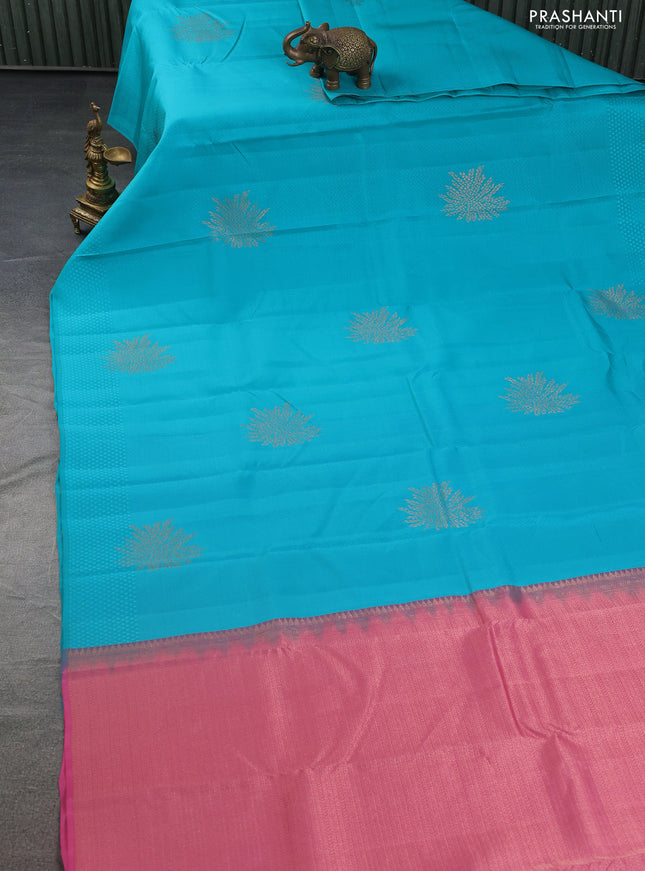 Kanchipuram silk saree teal blue and peach pink with allover self emboss & copper zari buttas in borderless style