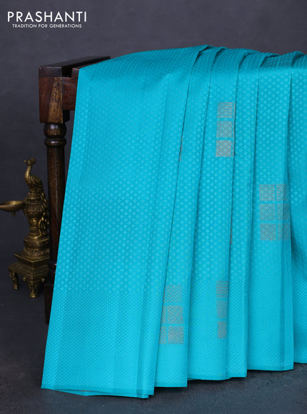 Kanchipuram silk saree teal blue and reddish orange with allover self emboss & copper zari buttas in borderless style