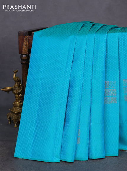 Kanchipuram silk saree dual shade of teal bluish green and dual shade of pinkish orange with allover self emboss & copper zari buttas in borderless style