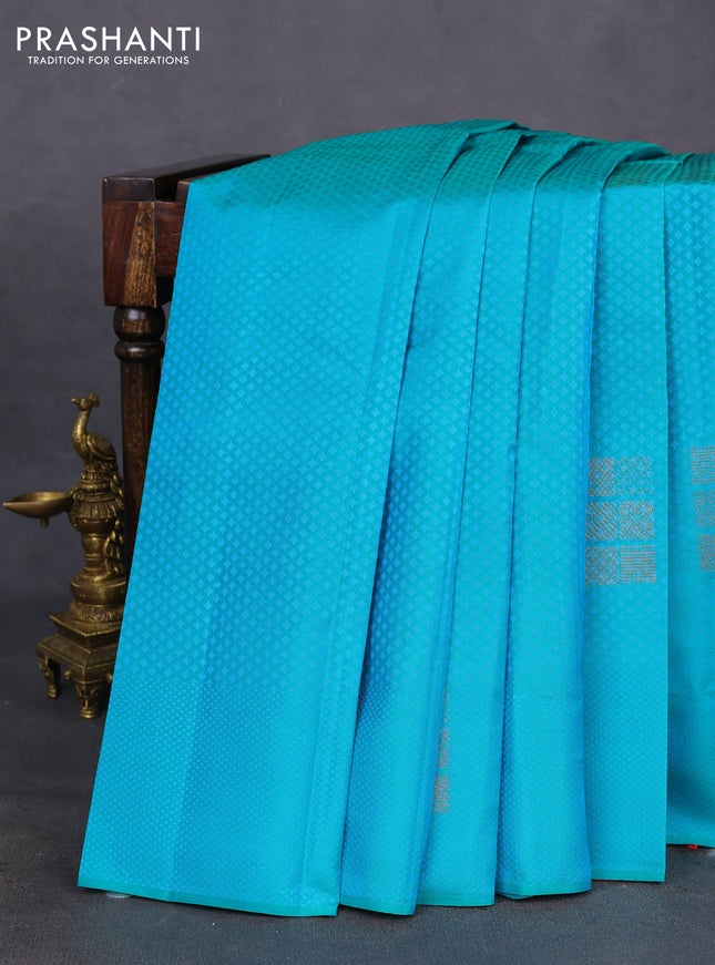 Kanchipuram silk saree dual shade of teal bluish green and dual shade of pinkish orange with allover self emboss & copper zari buttas in borderless style