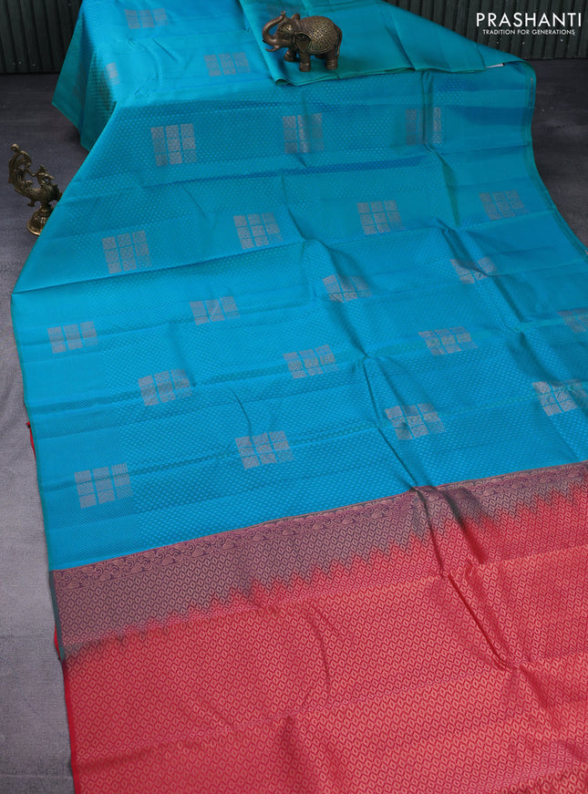 Kanchipuram silk saree dual shade of teal bluish green and dual shade of pinkish orange with allover self emboss & copper zari buttas in borderless style