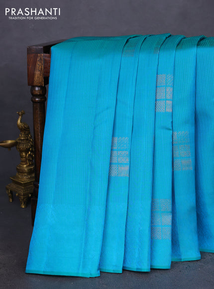 Kanchipuram silk saree teal bluish green and reddish orange with allover self emboss & copper zari buttas in borderless style