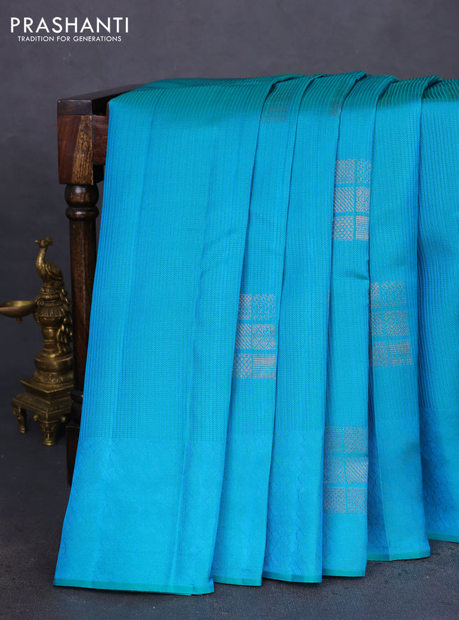 Kanchipuram silk saree teal bluish green and reddish orange with allover self emboss & copper zari buttas in borderless style