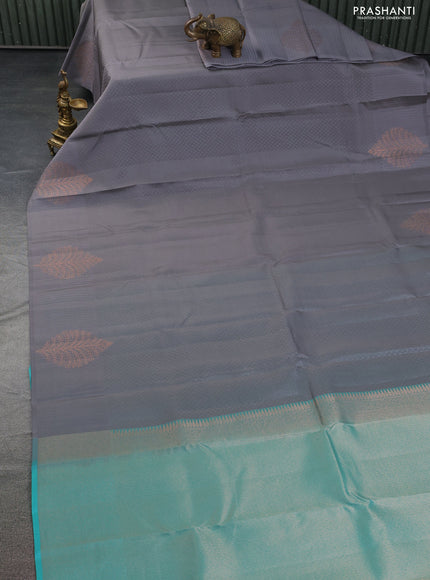 Kanchipuram silk saree grey and teal blue with allover self emboss and copper zari woven butta border
