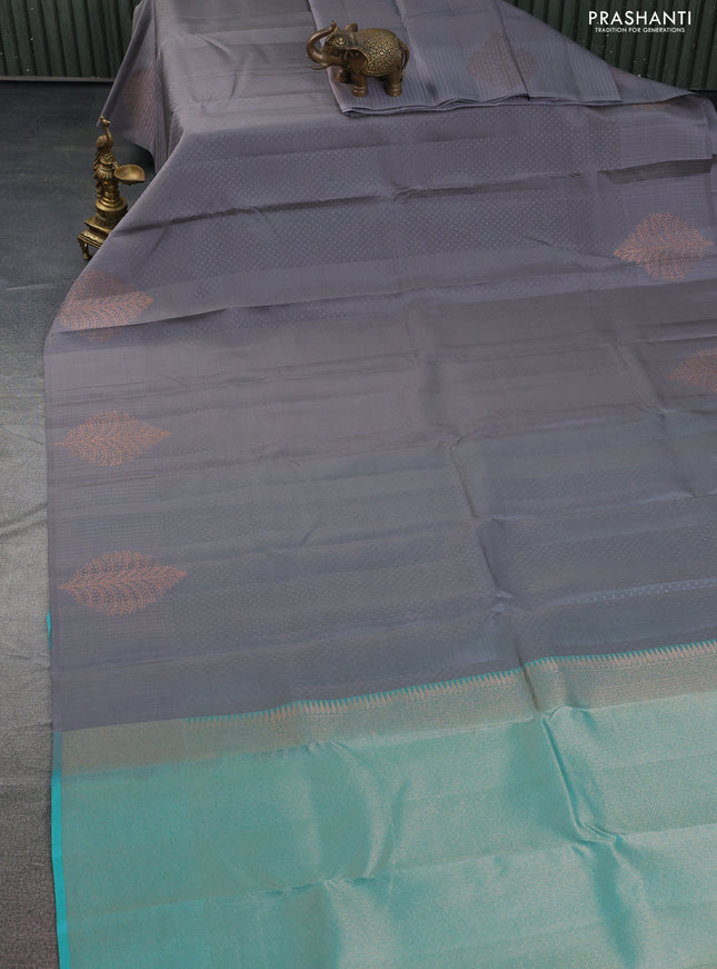 Kanchipuram silk saree grey and teal blue with allover self emboss and copper zari woven butta border