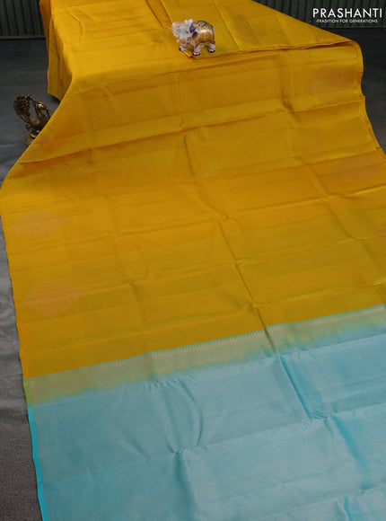 Kanchipuram silk saree mustard yellow and teal blue with allover self emboss and copper zari woven butta border