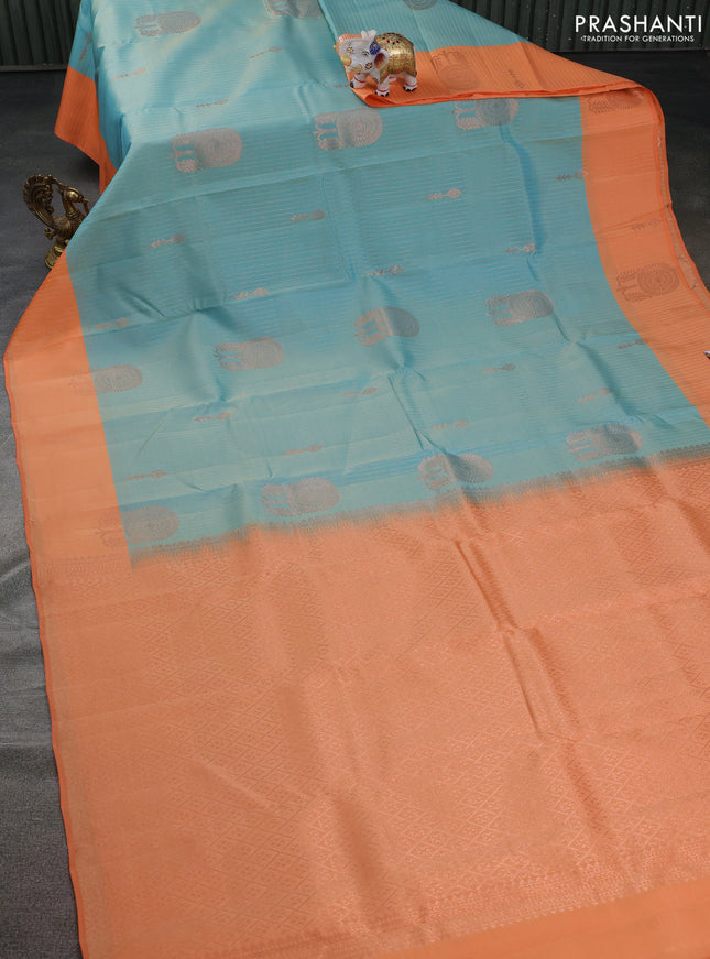 Kanchipuram silk saree dual shade of teal blue and orange with allover copper zari weaves and copper zari woven border