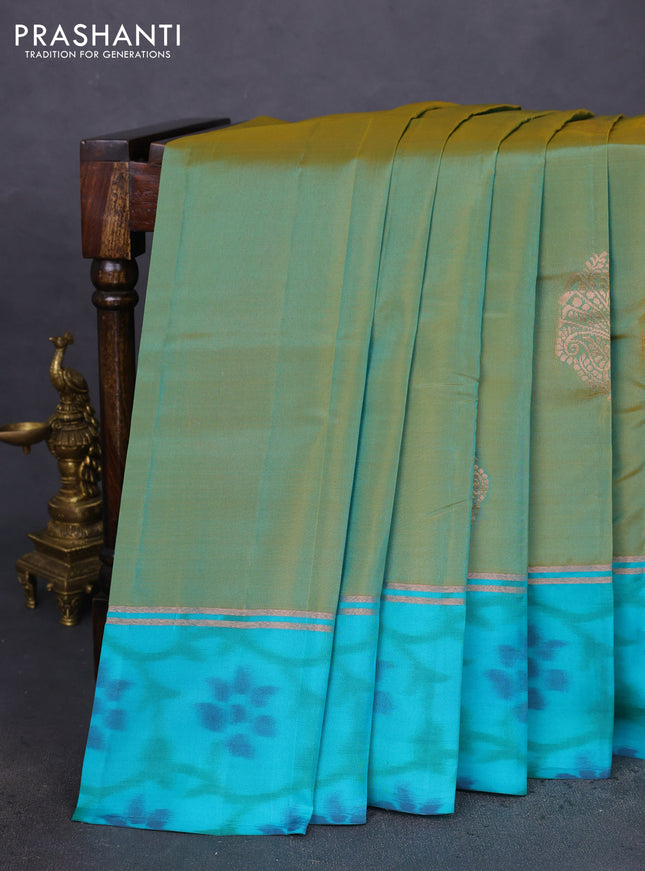Kanchipuram silk saree dual shade of teal bluish mustard and teal blue shade with copper zari woven buttas and copper zari woven ikat style border