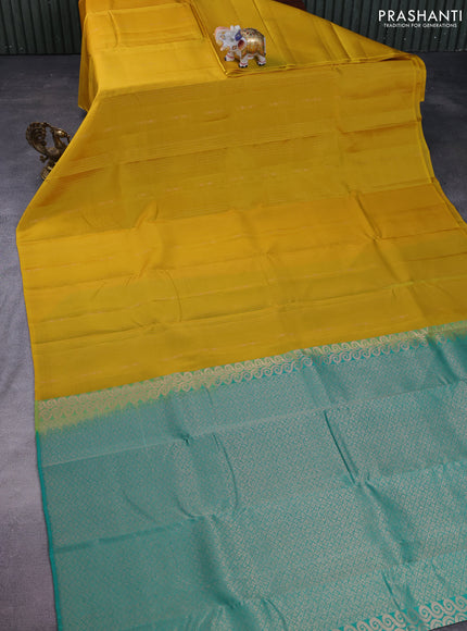 Kanchipuram silk saree yellow and teal green with allover copper zari weaves & buttas in borderless style