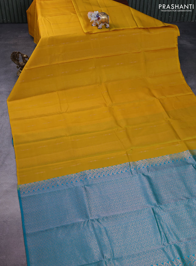 Kanchipuram silk saree yellow and teal green with allover copper zari weaves & buttas in borderless style