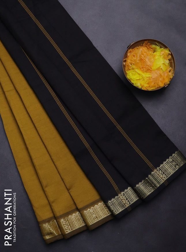 Semi silk cotton saree dark mustard and black with plain body and zari woven border