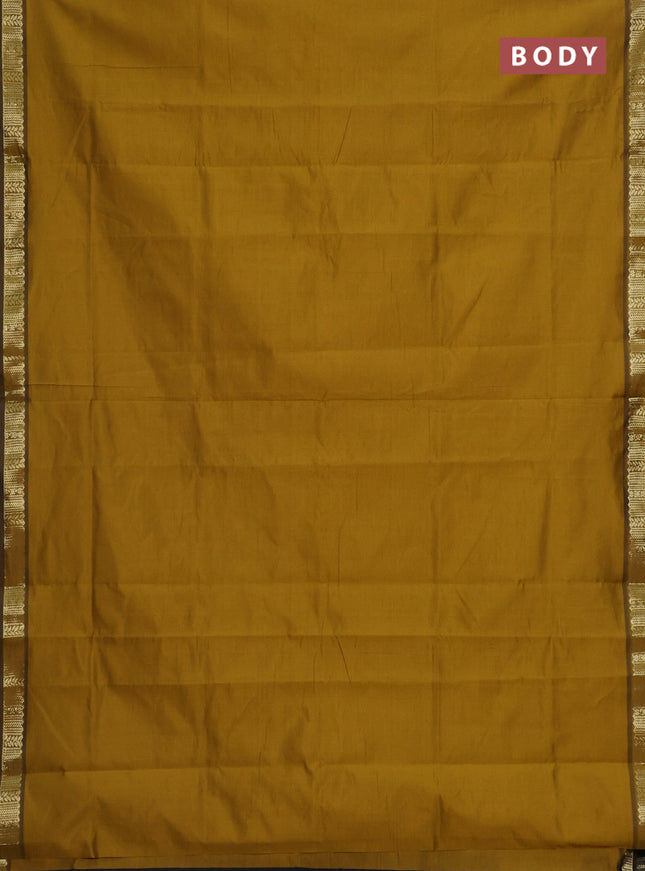 Semi silk cotton saree dark mustard and black with plain body and zari woven border