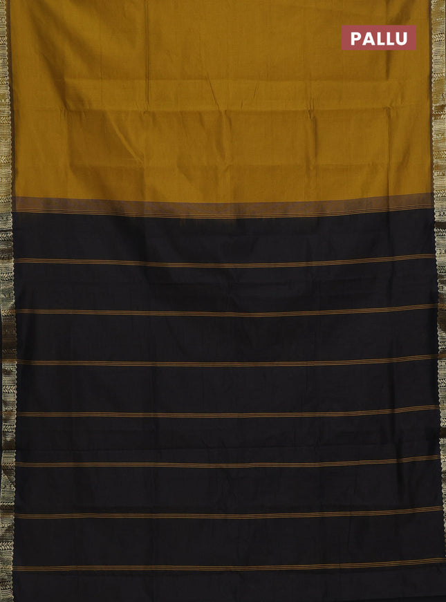 Semi silk cotton saree dark mustard and black with plain body and zari woven border