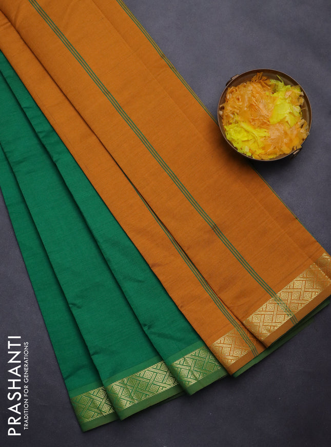 Semi silk cotton saree green and dark mustard with plain body and zari woven border