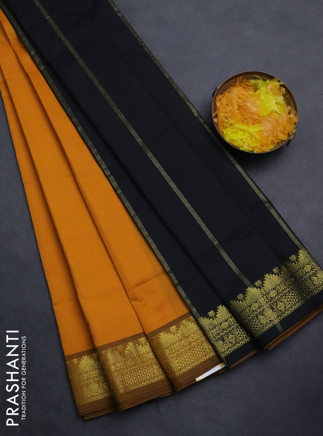Semi silk cotton saree mustard yellow and black with plain body and zari woven border