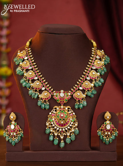Jadau maanga necklace floral pendant with jadau stones and green beads hanging