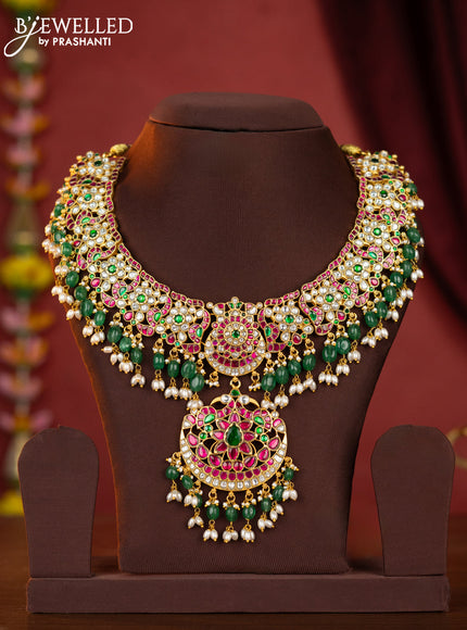 Jadau necklace double peacock floral pendant with jadau stones and green beads hanging