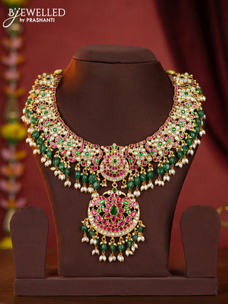 Jadau necklace double peacock floral pendant with jadau stones and green beads hanging