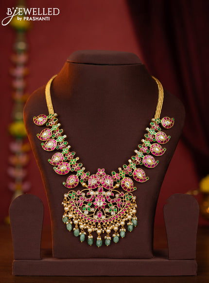 Jadau maanga necklace floral pendant with jadau stones and green beads hanging