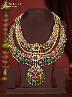 Jadau triple layer bridal floral pendant necklace with jadau kundan stones and green beads hanging