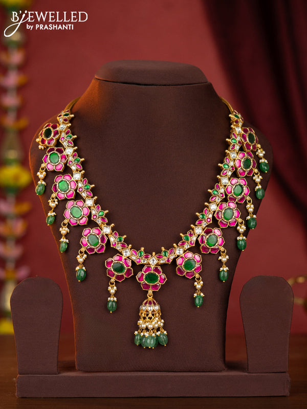 Jadau floral necklace with half jhumka pendant,jadau stones and green beads hanging