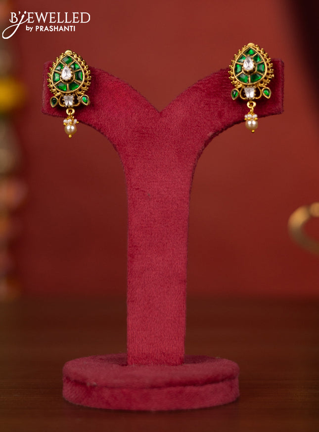 Jadau leaf floral design earring with green jadau stones and pearl hanging