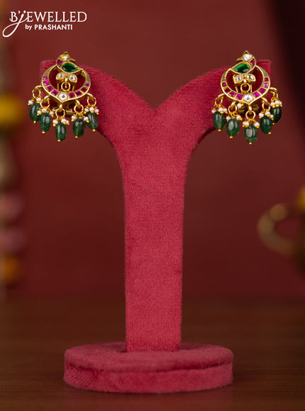 Jadau peacock earring with jadau kundan stones and green beads hanging