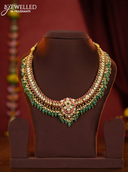 Jadau necklace with double peacock centre pendant made with jadau kundan stones and green beads hanging