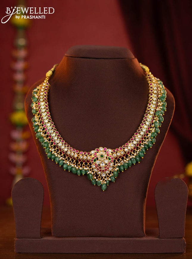Jadau necklace with double peacock centre pendant made with jadau kundan stones and green beads hanging