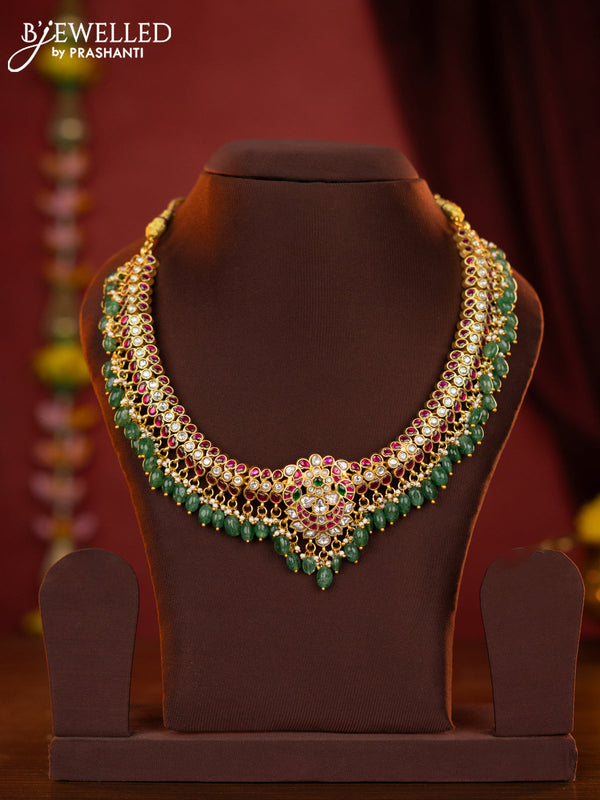 Jadau necklace with double peacock centre pendant made with jadau kundan stones and green beads hanging