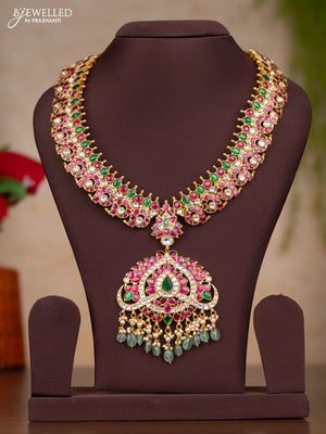 Jadau haaram with manga design with floral pendant in jadau kundan stones and mint green hanging