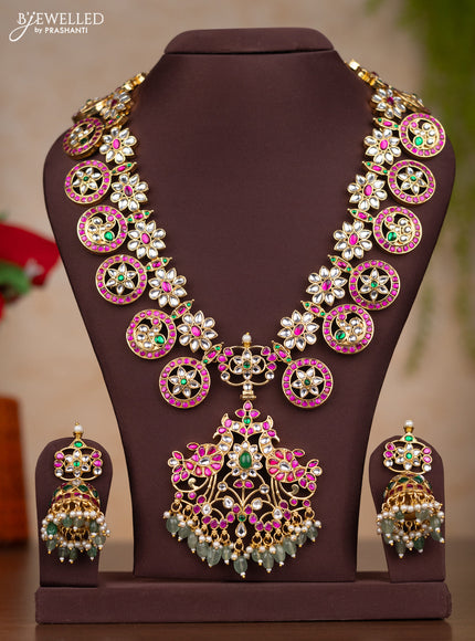 Jadau haaram bottumala with floral deisgn through out the neckline and pendant in floral with mint green beads hanging