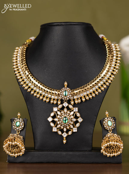 Antique necklace with floral design in kundan stones and pearl throughout the neckline