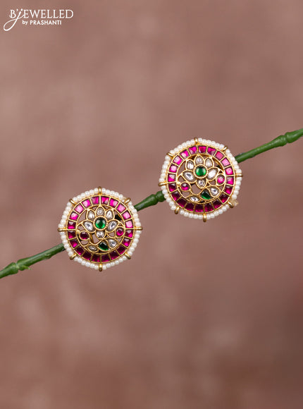 Jadau earrings floral deisgn with jadau kundan stones surrounded with white beads