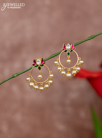 Jadau earrings in lotus design in jadau kundan stones and pearl hanging