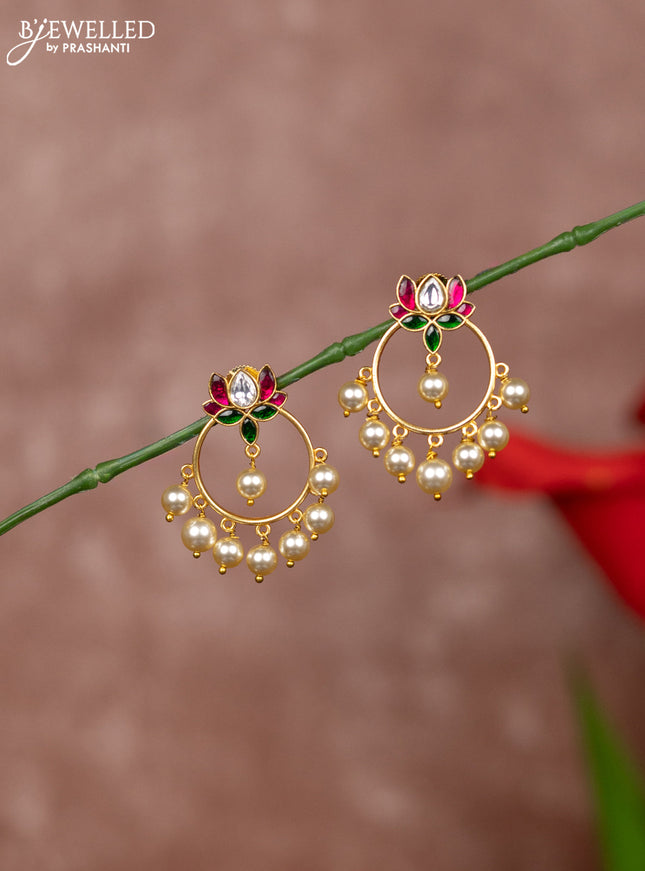 Jadau earrings in lotus design in jadau kundan stones and pearl hanging