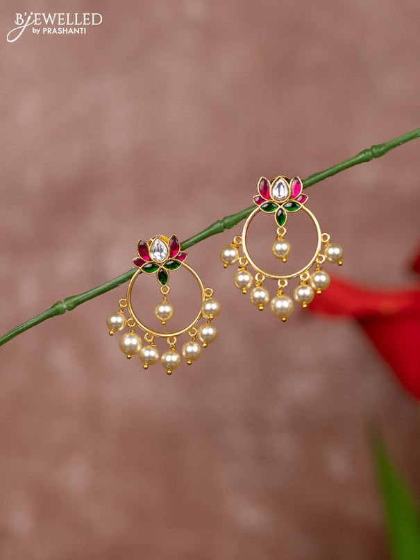 Jadau earrings in lotus design in jadau kundan stones and pearl hanging