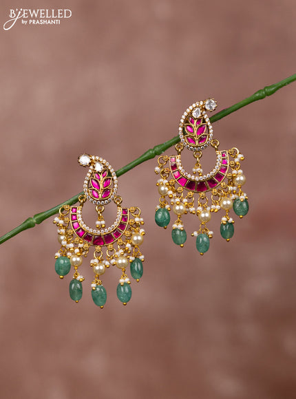 Jadau earrings leaf deisgn with jadau kundan stones and green beads hanging
