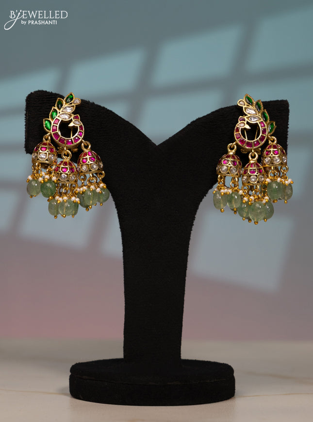 Jadau screw type jhumka peacock design with kemp jadau kundan stones in pearl & mint green beads hangings