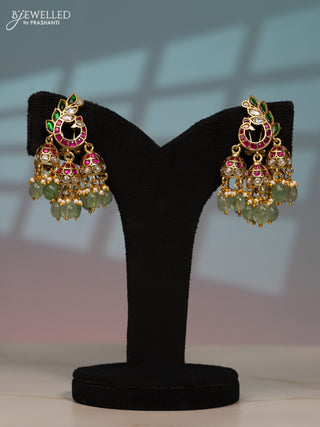 Jadau screw type jhumka peacock design with kemp jadau kundan stones in pearl & mint green beads hangings