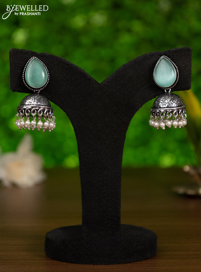 Oxidised jhumka with mint green stones and pearl hangings