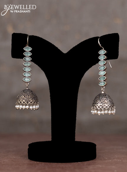 Oxidised hanging type jhumka with mint green stones and pearl hangings