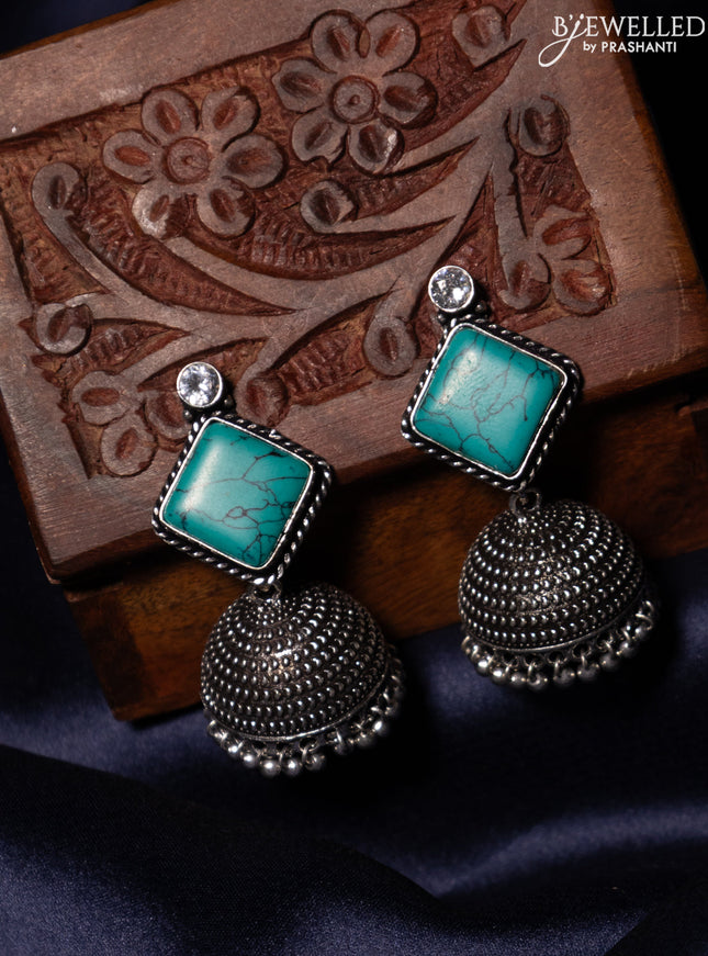 Oxidised jhumka with teal green & white stones and silver beads hanging