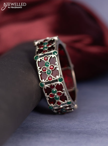 Oxidised screw type bangle with ruby and emerald stones