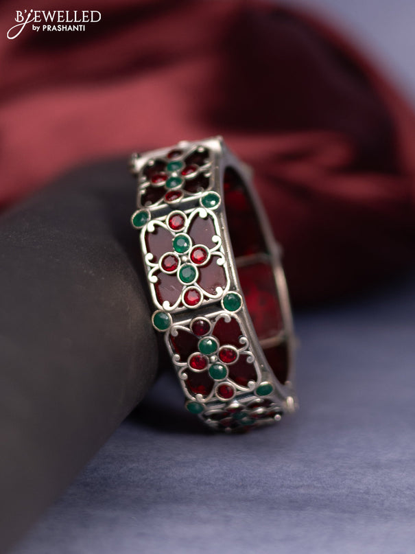 Oxidised screw type bangle with ruby and emerald stones
