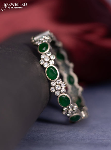 Oxidised screw type bangle with emerald and cz stones